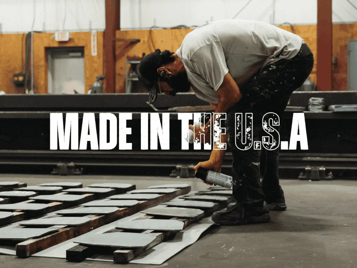Worker preparing steel plates for body armor in U.S. manufacturing facility